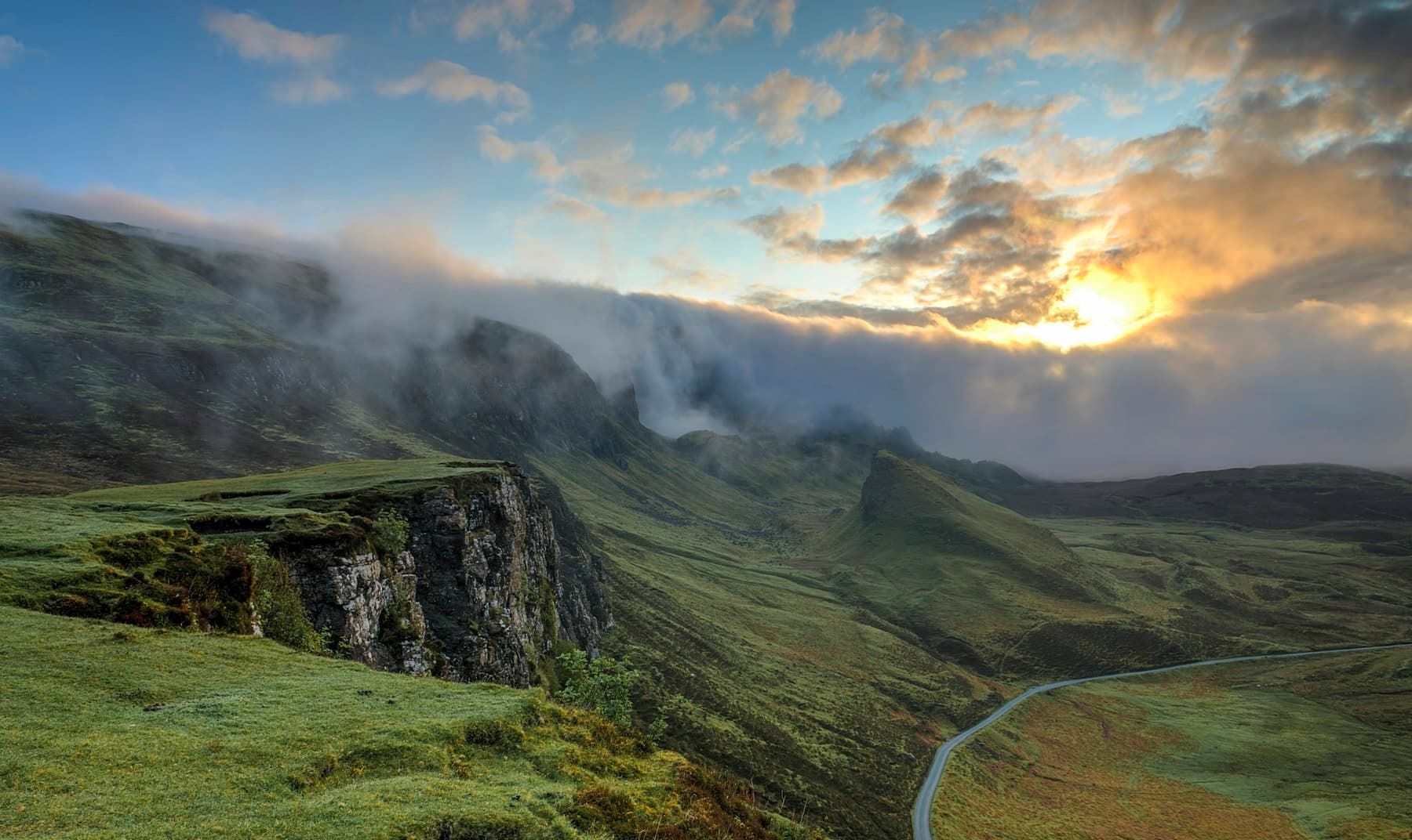 A highland road at first light, the path still being drawn.